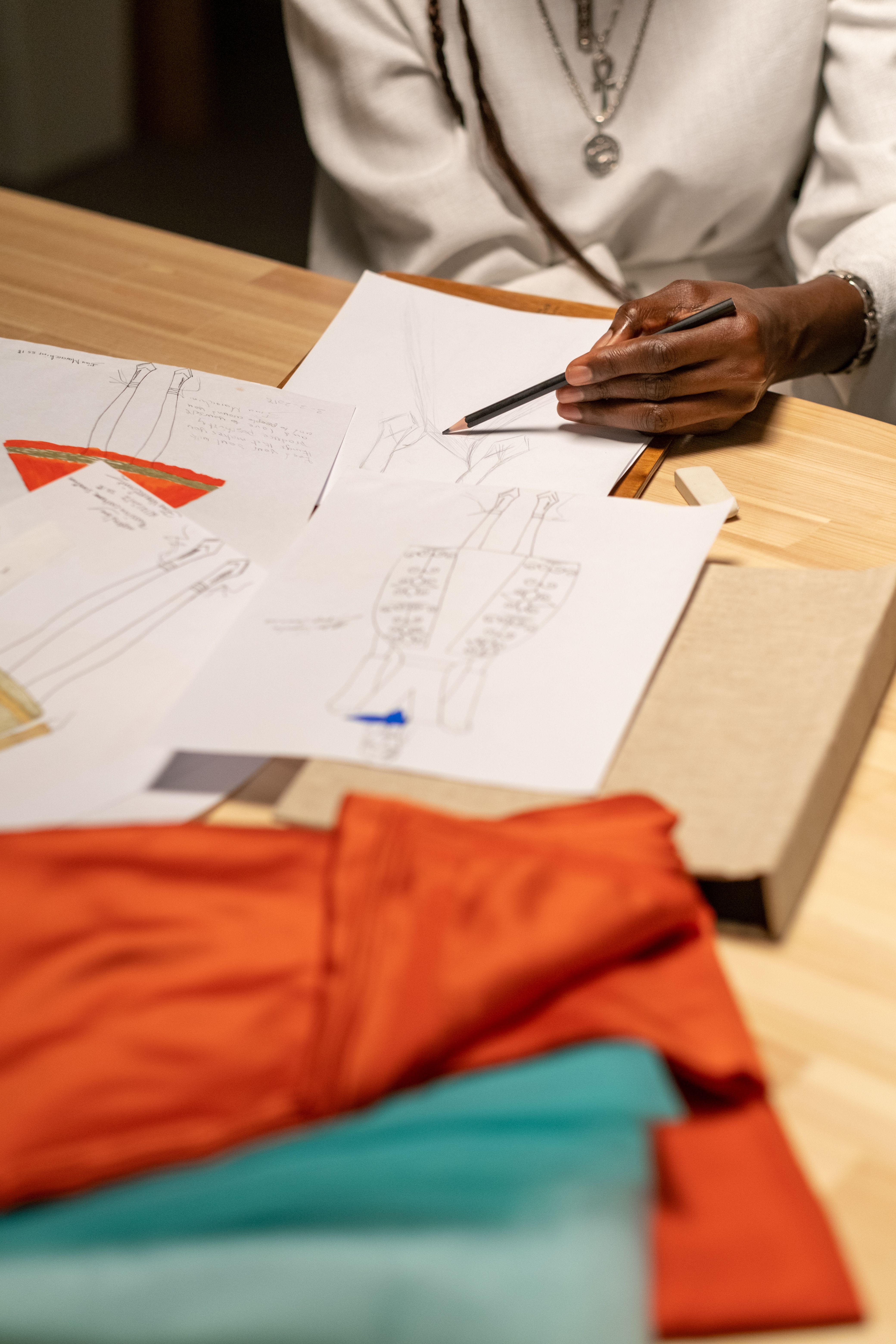 Fashion designer developing new clothing designs with fabric samples