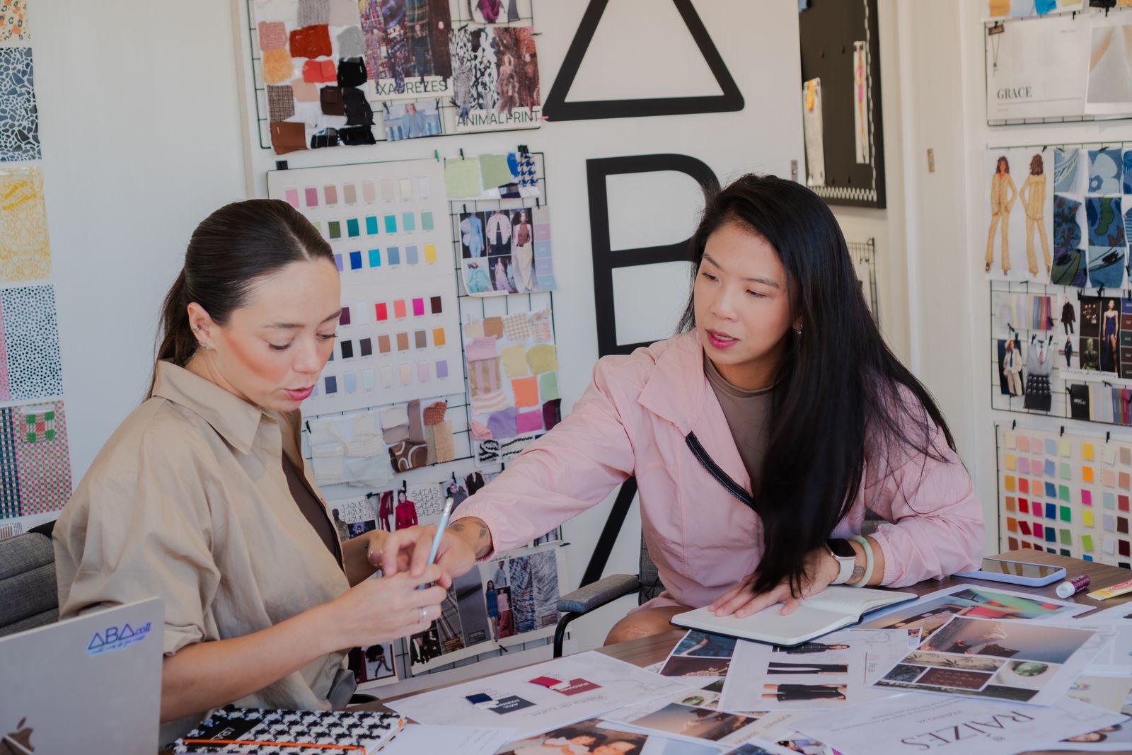 Apparel professionals developing garments with swatches and sketches